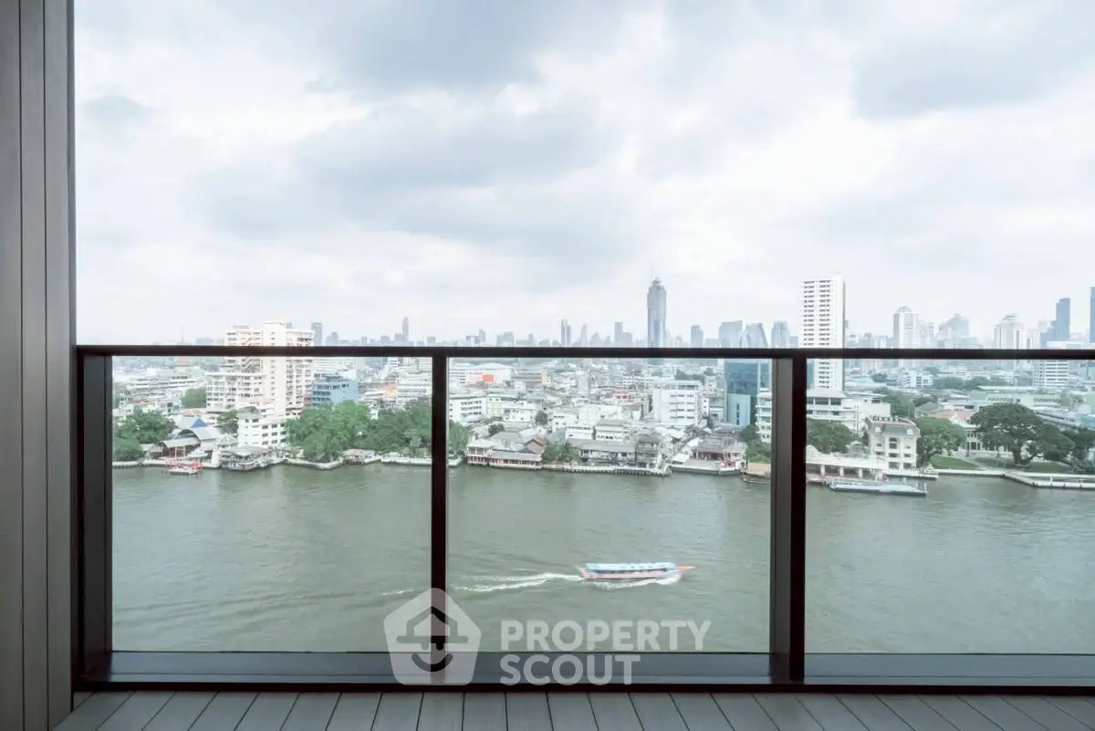 Stunning river view from a modern balcony in a high-rise apartment, showcasing city skyline.