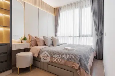 Luxurious bedroom with elegant decor and large window offering natural light.