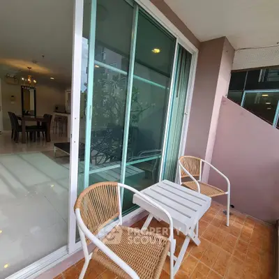 Charming balcony with cozy seating and view into modern dining area, perfect for relaxation and entertaining.