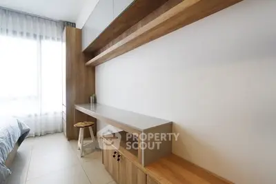 Modern study room with sleek wooden desk and ample natural light
