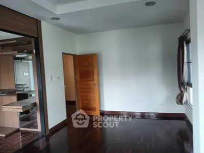 Spacious empty room with wooden flooring and built-in closet, ideal for customization.