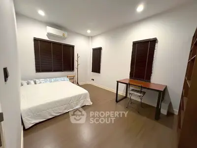 Spacious bedroom with modern furnishings and ample natural light