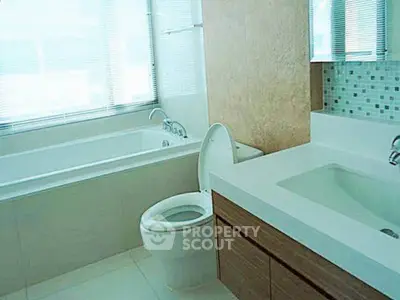 Modern bathroom with sleek fixtures and large bathtub in a bright, airy space.