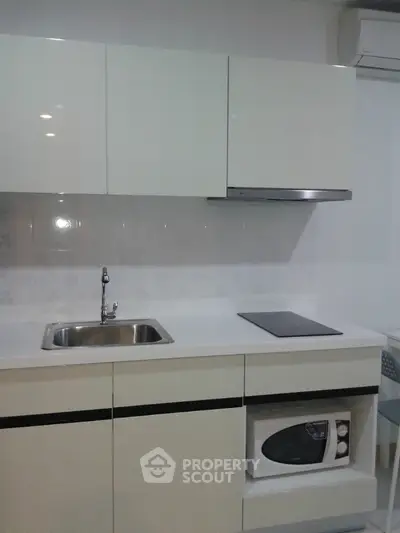 Modern minimalist kitchen with sleek white cabinetry and built-in appliances