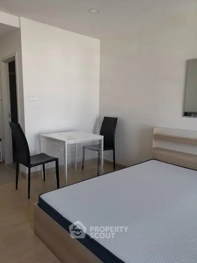 Modern minimalist bedroom with sleek furniture and natural light