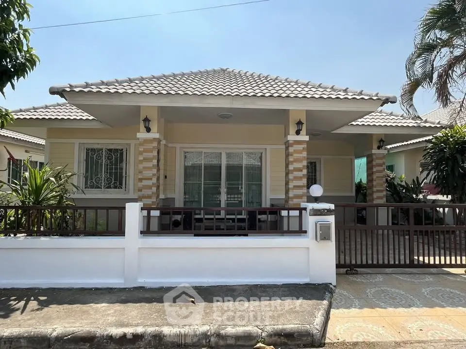 Charming single-story house with tiled roof and spacious front porch in a serene neighborhood.