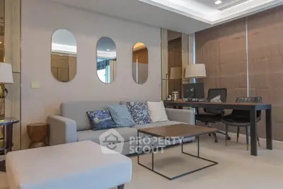 Modern living room with stylish decor and workspace, featuring a comfortable sofa and elegant lighting.