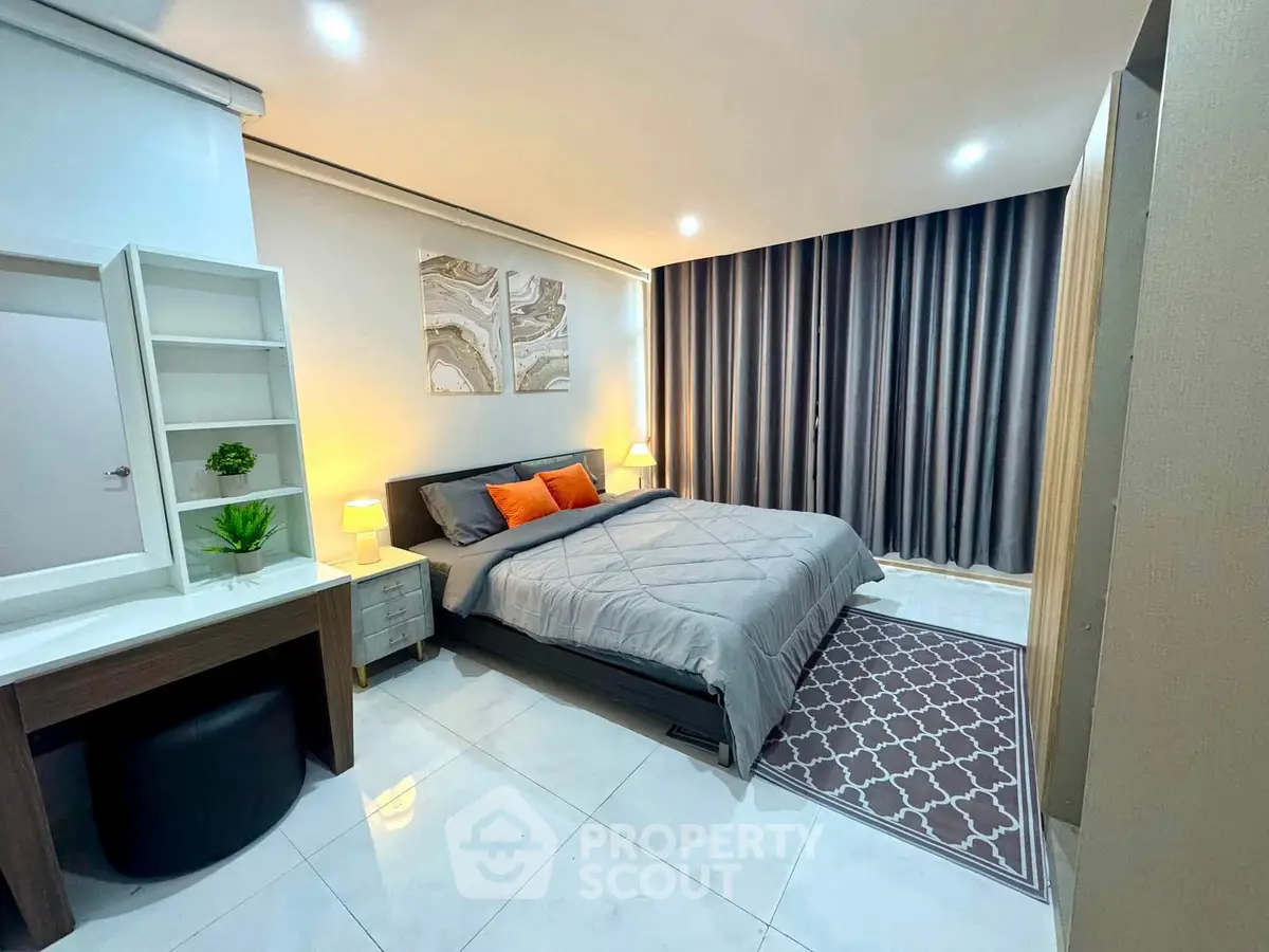 Modern bedroom with stylish decor, cozy bed, and elegant curtains in a contemporary apartment.