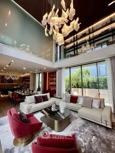 Luxurious double-height living room with modern chandelier and elegant decor