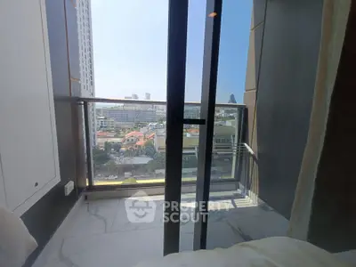 Modern apartment balcony with city view and glass railing, perfect for urban living.