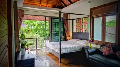 Luxurious bedroom with canopy bed and garden view in tropical villa