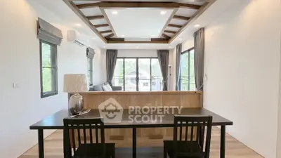 Modern living room with stylish ceiling design and large windows for natural light.