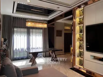 Luxurious living room with modern decor, elegant chandelier, and large windows for natural light.