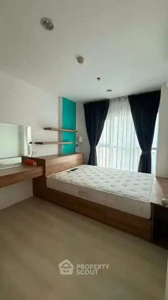 Modern bedroom with large window and stylish wooden furniture