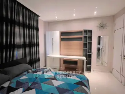 Modern bedroom with stylish decor and geometric bedding in a contemporary apartment.