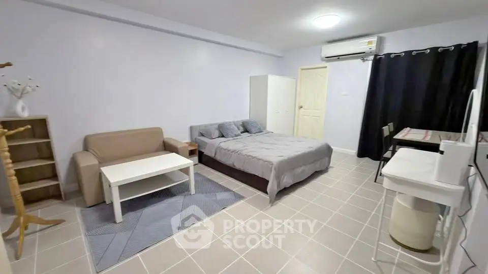 Spacious studio apartment with modern furnishings and air conditioning, perfect for comfortable urban living.