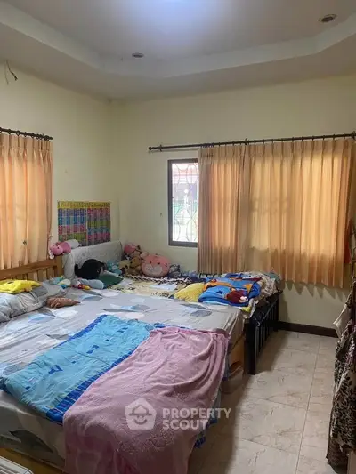 Cozy bedroom with natural light and comfortable bedding