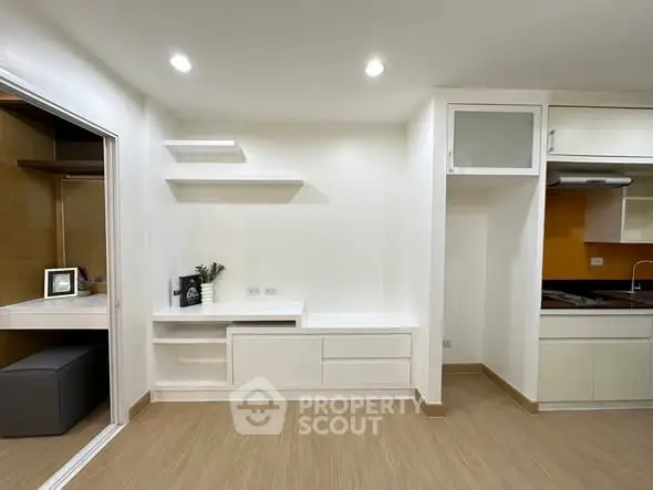 Modern minimalist living space with open kitchen and study nook