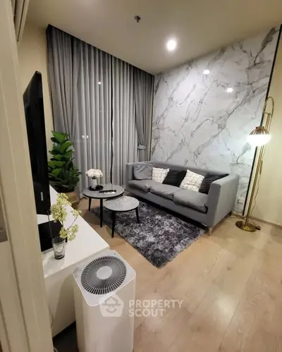Stylish modern living room with marble accent wall and cozy gray sofa
