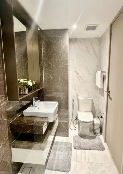Luxurious modern bathroom with elegant marble finishes and sleek fixtures.