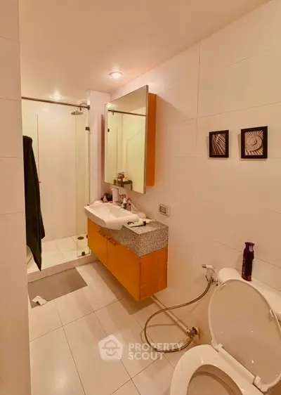 Modern bathroom with sleek design, featuring a glass shower and stylish vanity.