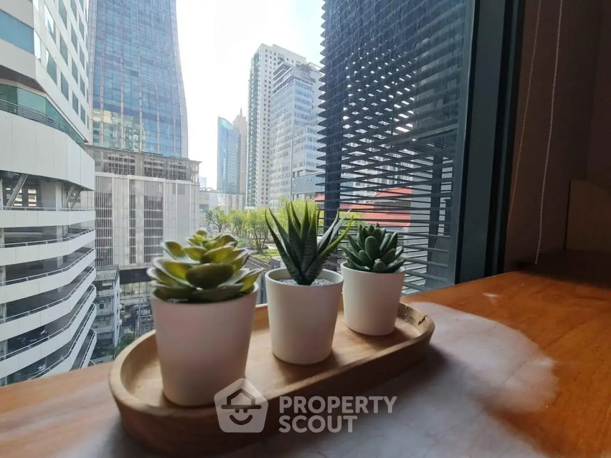 Stunning city view from modern apartment with stylish indoor plants