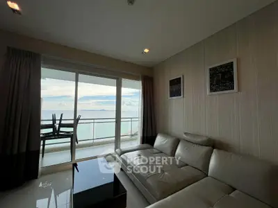 Luxurious living room with stunning ocean view and modern leather sofa.