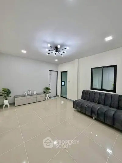 Modern living room with sleek furniture and stylish lighting in a contemporary home.