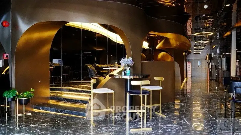 Luxurious modern lobby with sleek gold accents and marble flooring