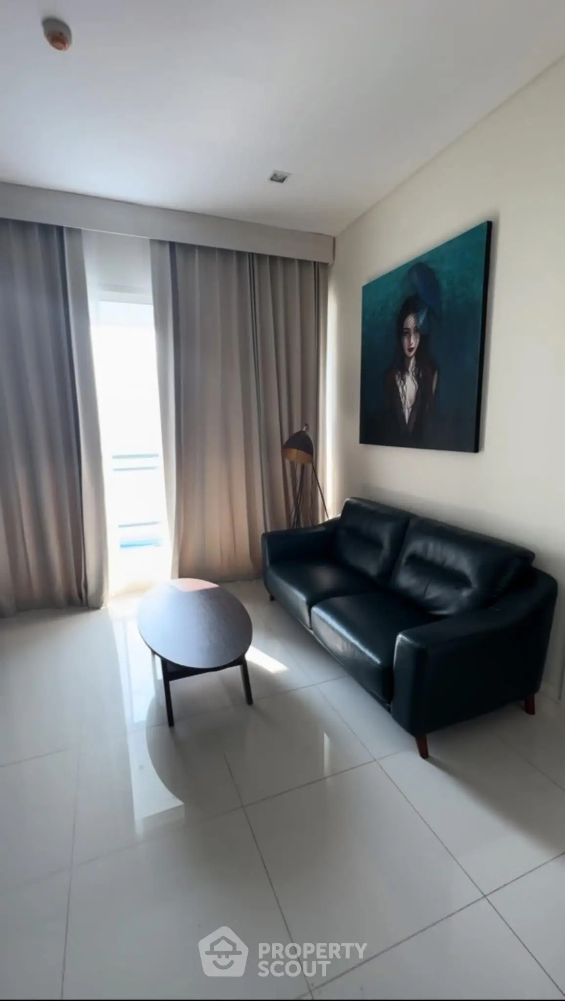Modern living room with sleek black sofa and stylish decor, perfect for urban living.