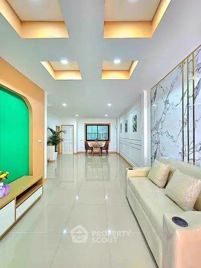 Modern living room with elegant ceiling design and marble accent wall