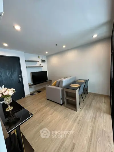 Modern living room with stylish decor and open layout, featuring a cozy sofa and elegant dining area.