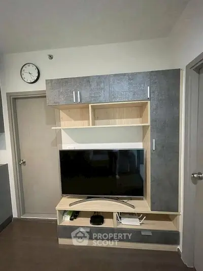 Modern living room with sleek TV unit and storage cabinets, perfect for contemporary living.