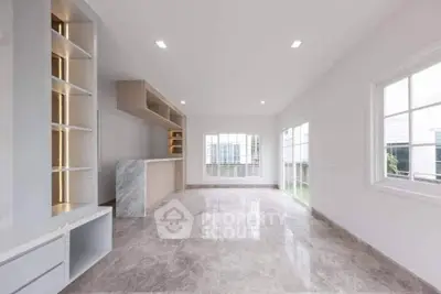 Spacious modern living room with marble flooring and large windows