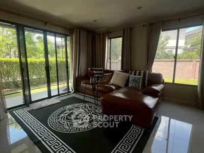 Spacious living room with large windows and stylish decor in a modern home.