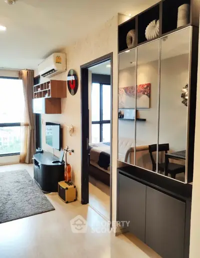 Modern living room with stylish decor and open view, featuring sleek furniture and natural light.