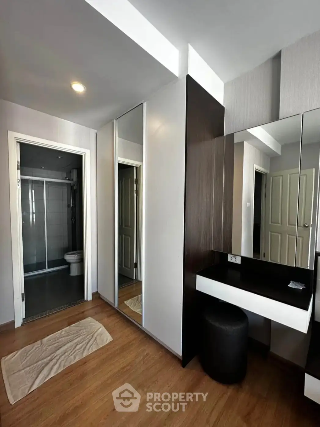 Modern bedroom with ensuite bathroom and stylish vanity area
