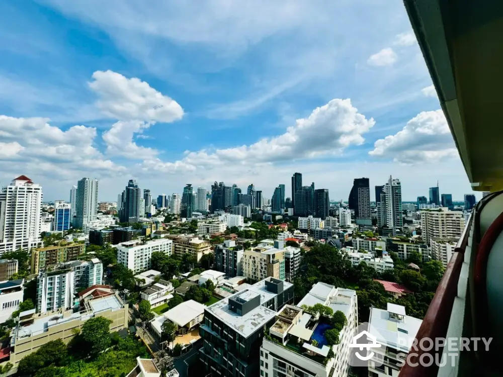 Stunning cityscape view from high-rise balcony showcasing urban skyline and vibrant city life.