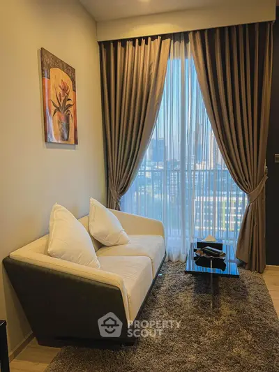 Cozy living room with elegant decor and city view through large window.