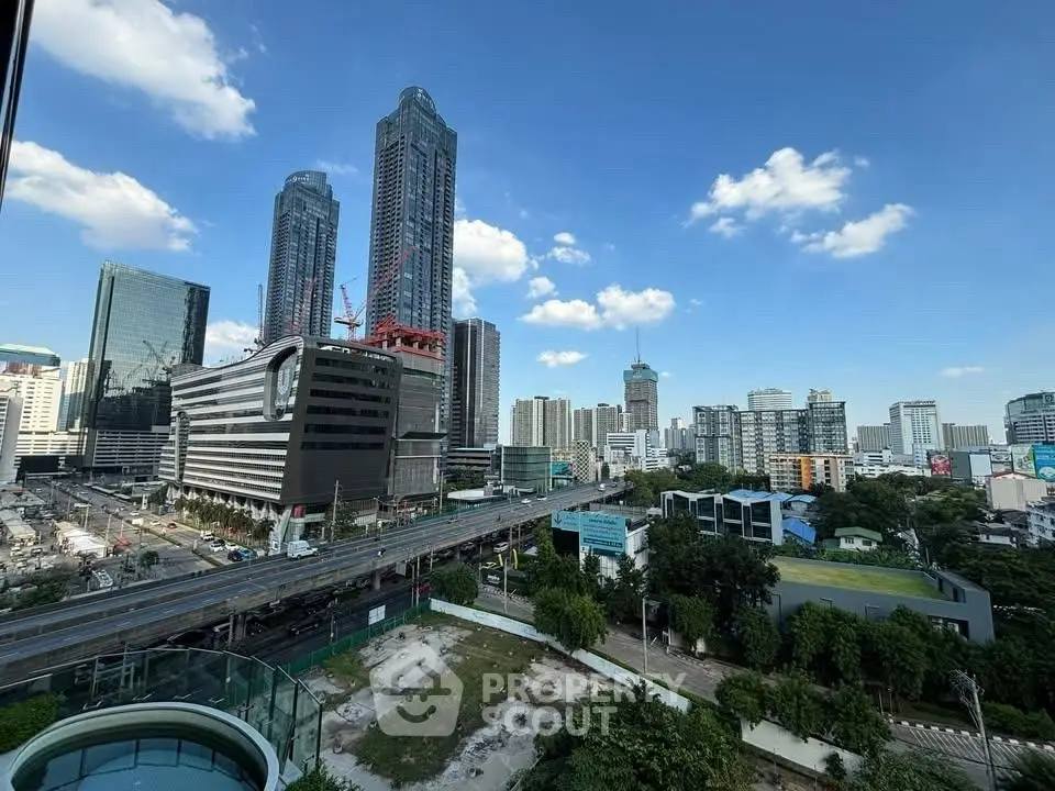 Stunning cityscape view with modern skyscrapers and clear blue sky, perfect for urban living enthusiasts.