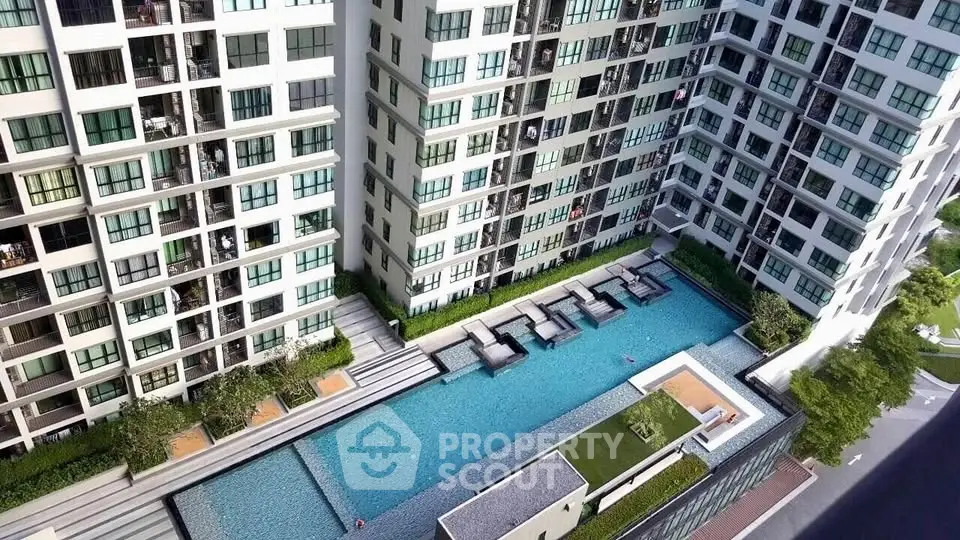 Luxurious condominium with stunning pool and modern architecture in urban setting.