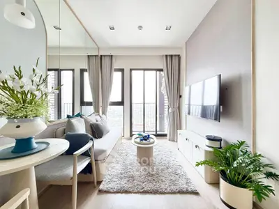 Modern living room with large windows, cozy seating, and stylish decor