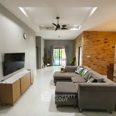 Spacious living room with modern decor and pool view