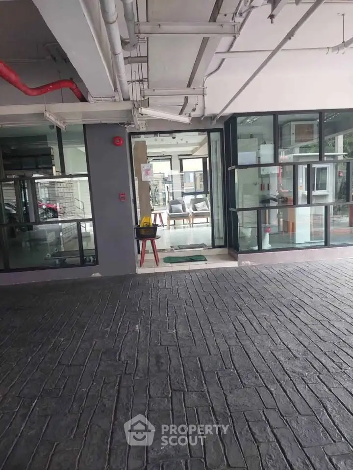 Modern building entrance with glass doors and stylish flooring