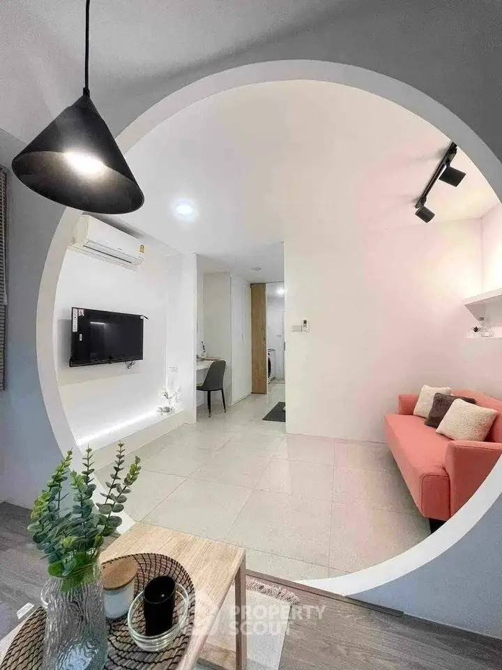Modern living room with stylish decor and circular wall opening