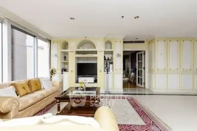 Luxurious living room with elegant decor and large windows in a high-end apartment.