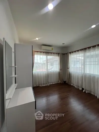Spacious corner unit with large windows and wooden flooring, perfect for natural light lovers.