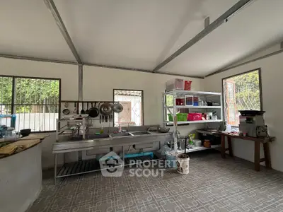 Spacious kitchen with open shelving and stainless steel sink