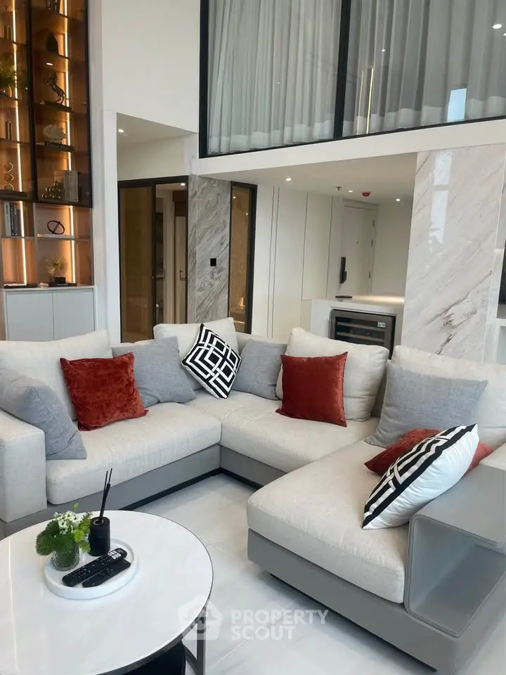 Luxurious modern living room with elegant decor and spacious seating area.
