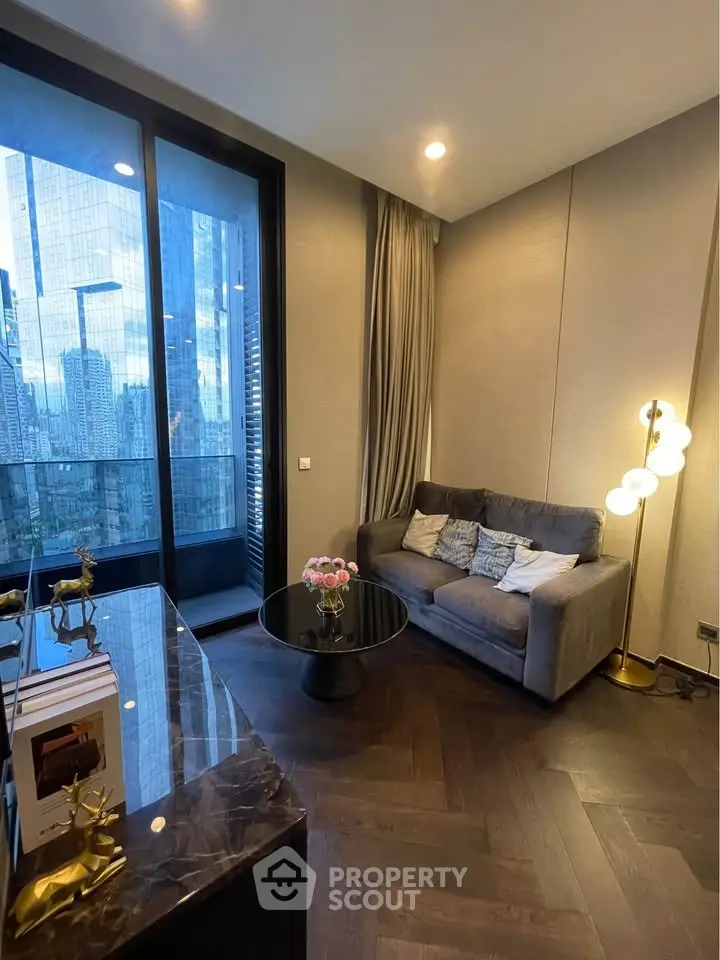 Modern living room with city view, featuring elegant decor and cozy seating area.